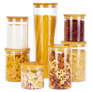 Glass jars filled with pasta, beans, cereal, sugar, and oats