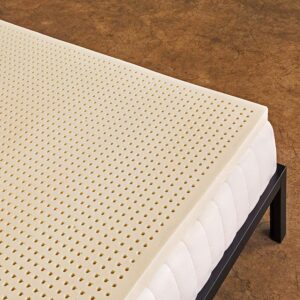 Mattress topper with small holes on top of a quilted mattress