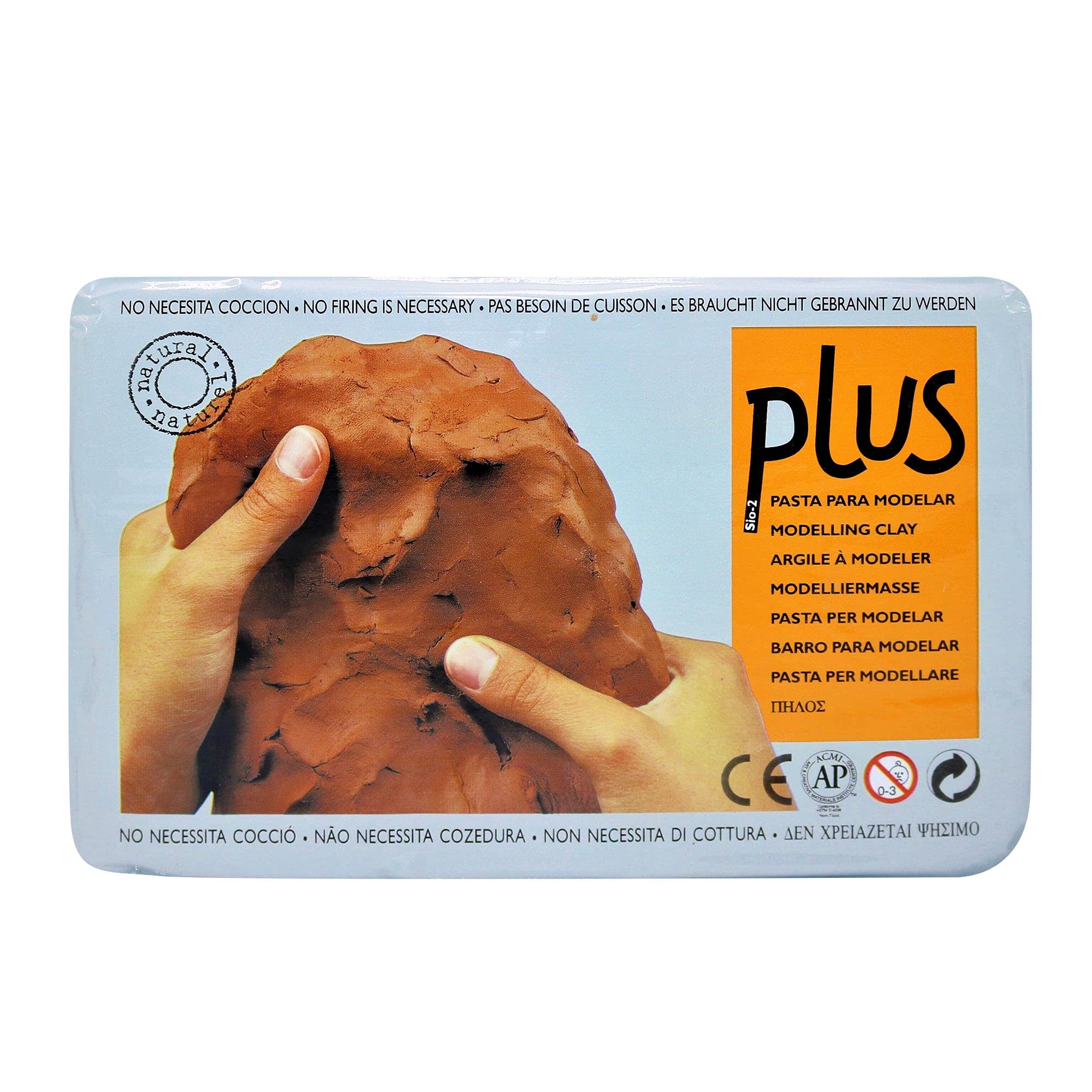Hands holding a brown modeling clay block on a package labeled "plus"