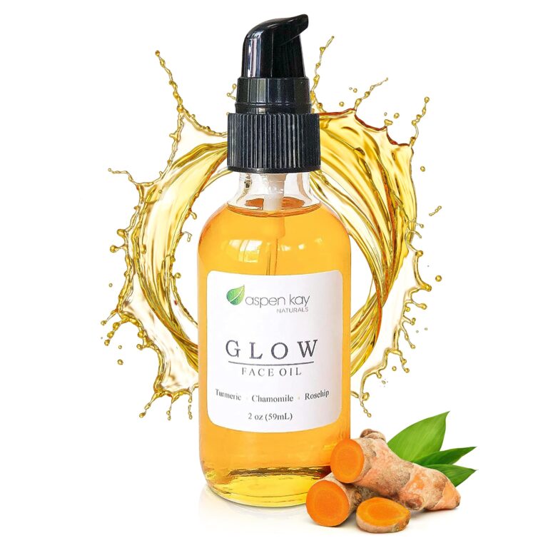 Face oil bottle with turmeric and oil splash on white background