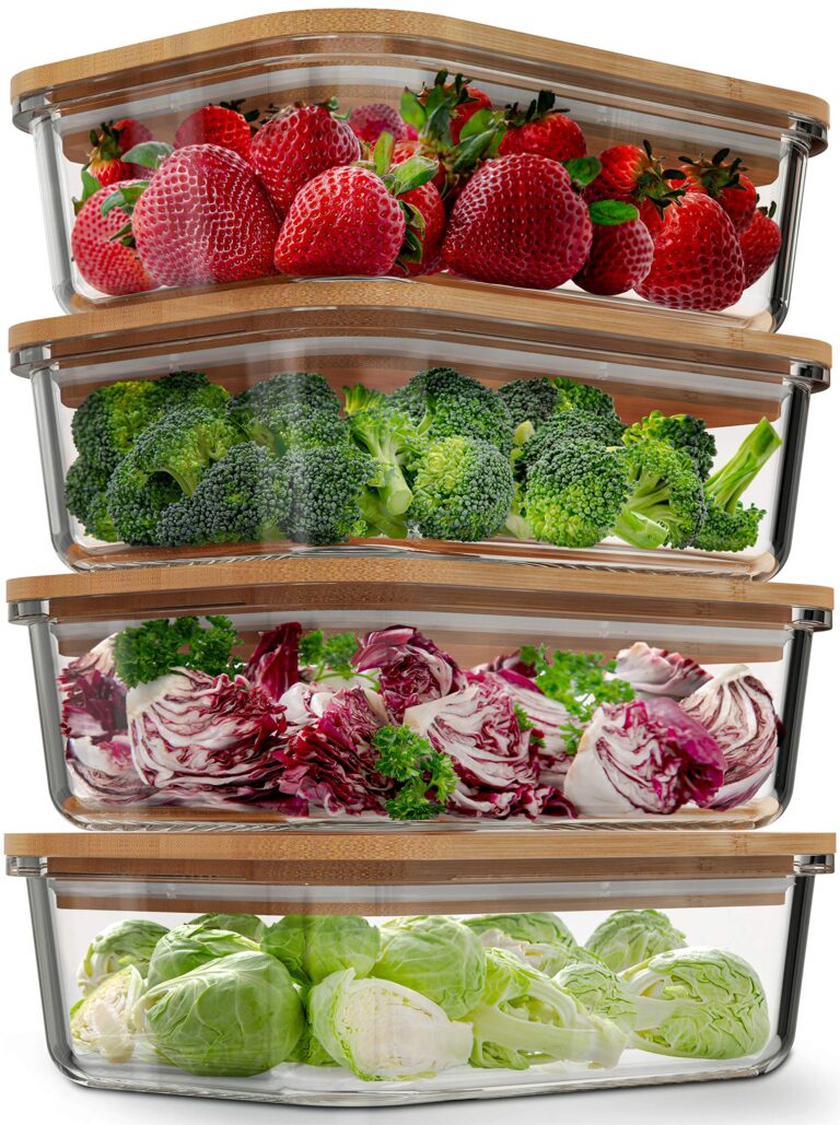 Four glass food storage containers filled with strawberries, broccoli, radicchio, and Brussels sprouts